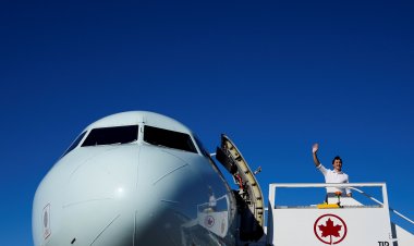 People wait in line as polls open in Canada's snap election