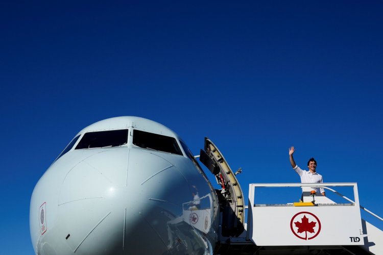 People wait in line as polls open in Canada's snap election