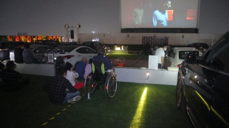 Drums, cake and milk as Indian cinemas dance back to life